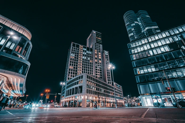 a city street at night with lit up buildings