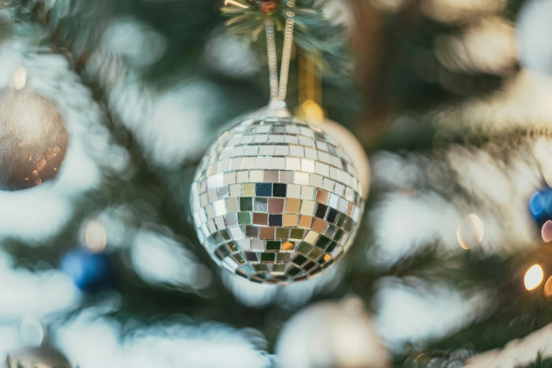 a disco ball hanging from the christmas tree