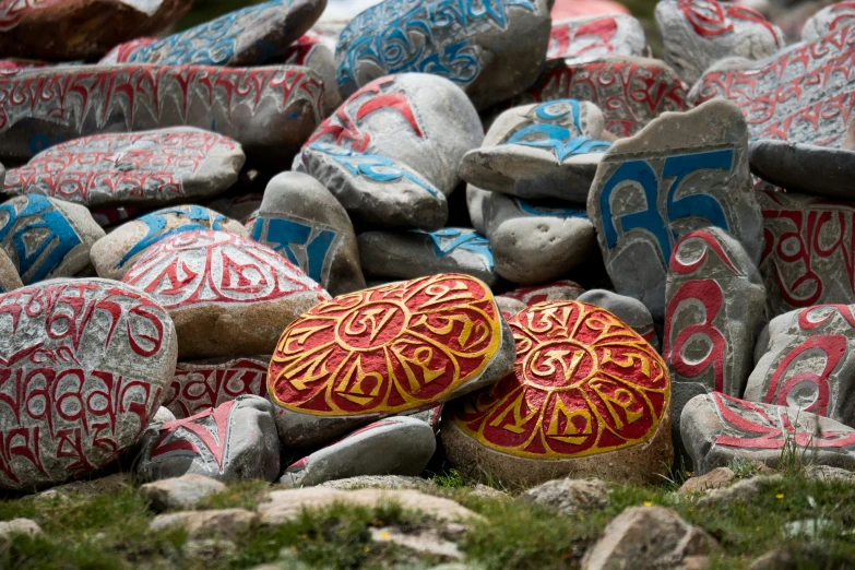 several painted rocks with designs and patterns on them