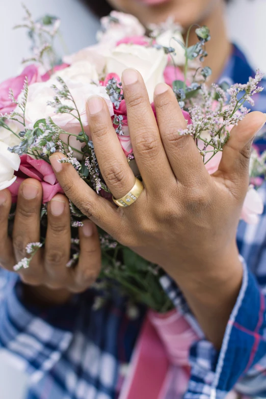 a woman with her hands on some flowers