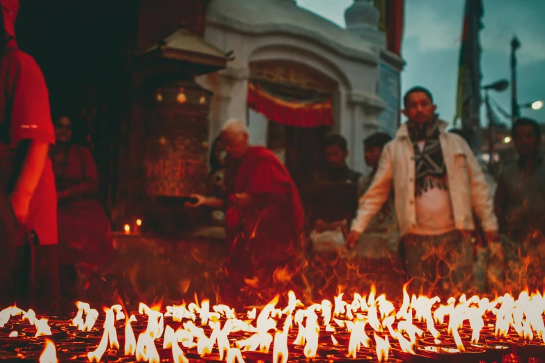 a group of people gathered around a lit candle