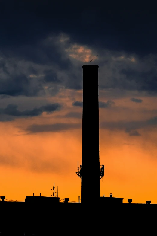 a silhouette view of the air traffic control tower at twilight