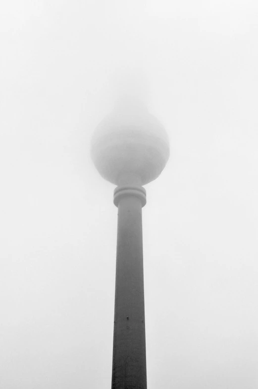 fog blankets the tower from low visibility in the area of berlin, germany