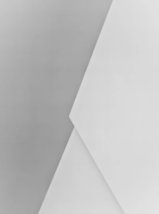 an abstract, white - toned pograph with the paper diagonal to the wall