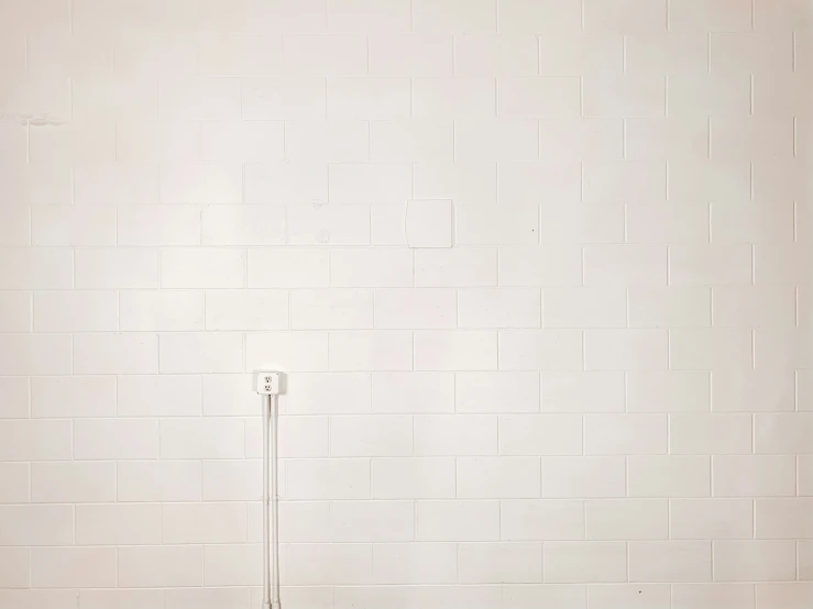 an empty room with a brown chair and white wall