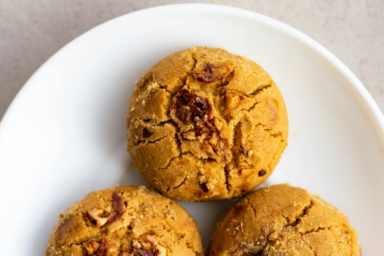 three deliciously made cookies are on a plate