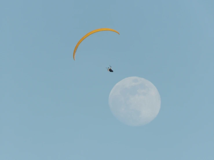 a parasail being flown in the blue sky