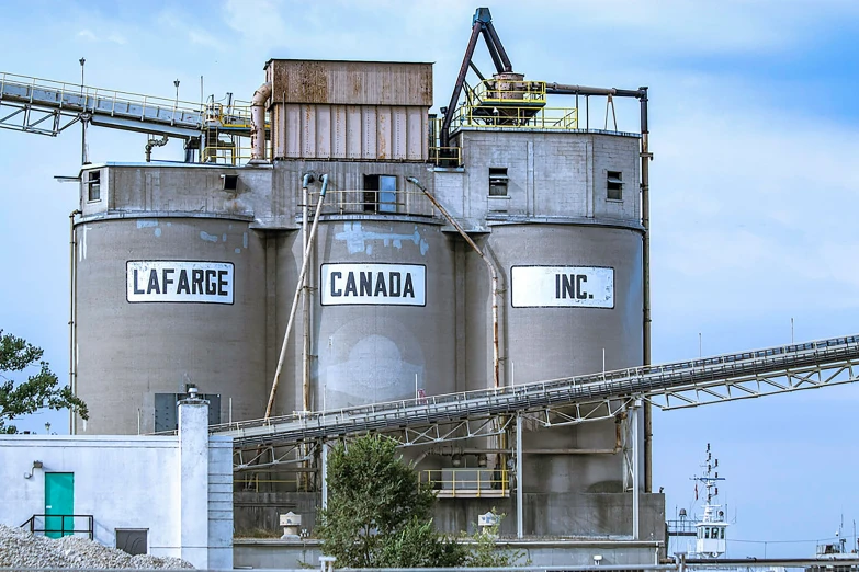 a factory with many storage tanks, and signs on them