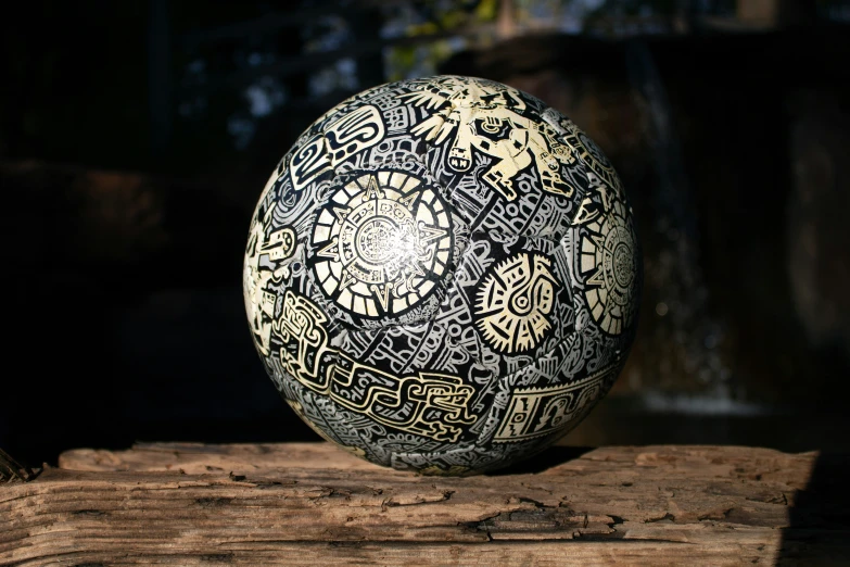 a close up of a sphere on a log