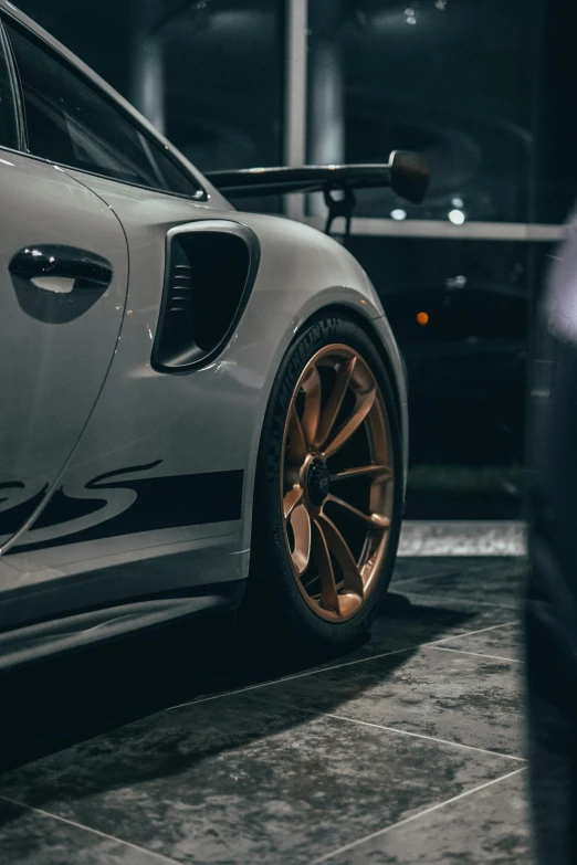 a car parked in a dark room next to two other cars