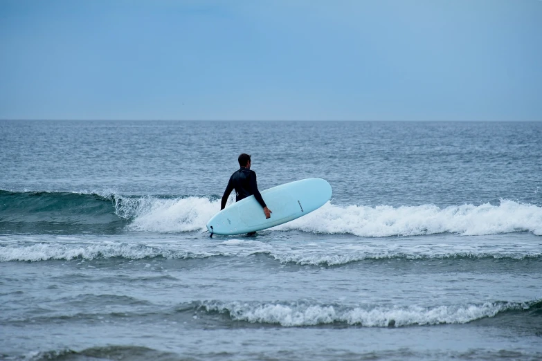 a man is riding the waves on his surfboard