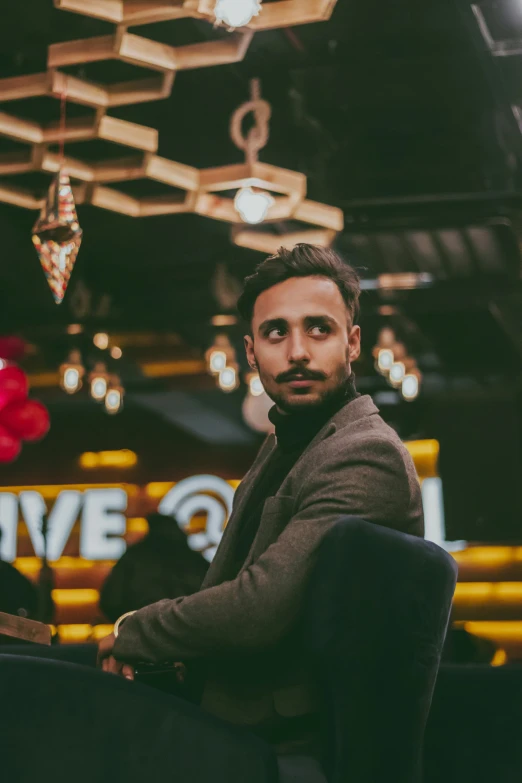 a man sitting at a table in a restaurant