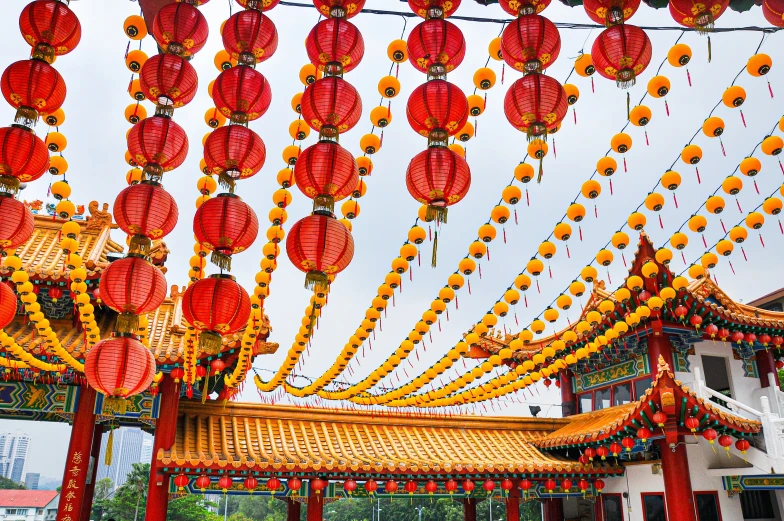 colorful asian lanterns hanging in the air at an outdoor festival