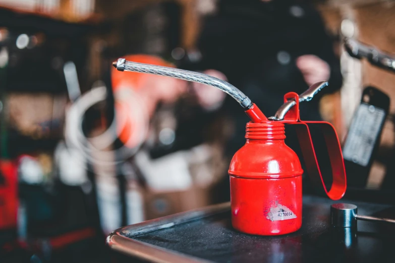 a red carafe sitting on top of a wooden table