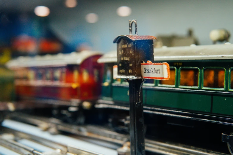 several model trains are shown lined up at a toy show