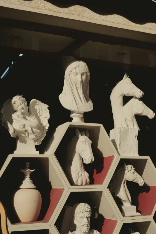 a display case of sculptures and busturines on a table