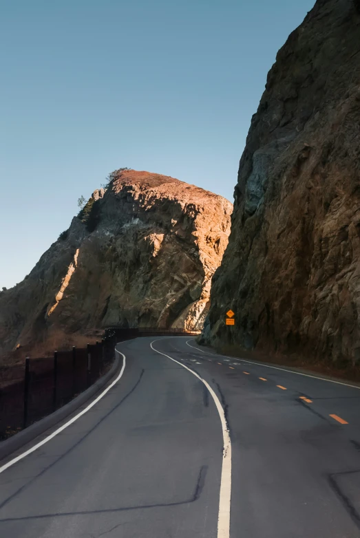 the long road passes by large rock formations