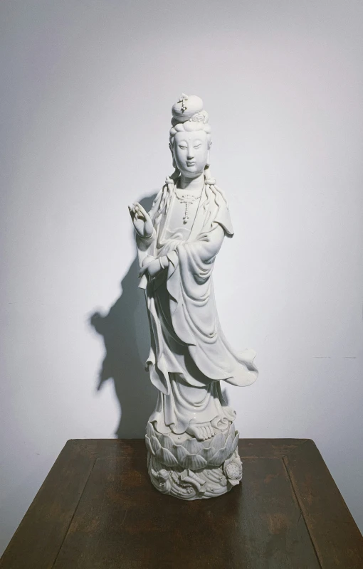 an antique statue is on display against the white wall