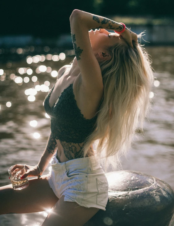 a woman holding up a glass in the air