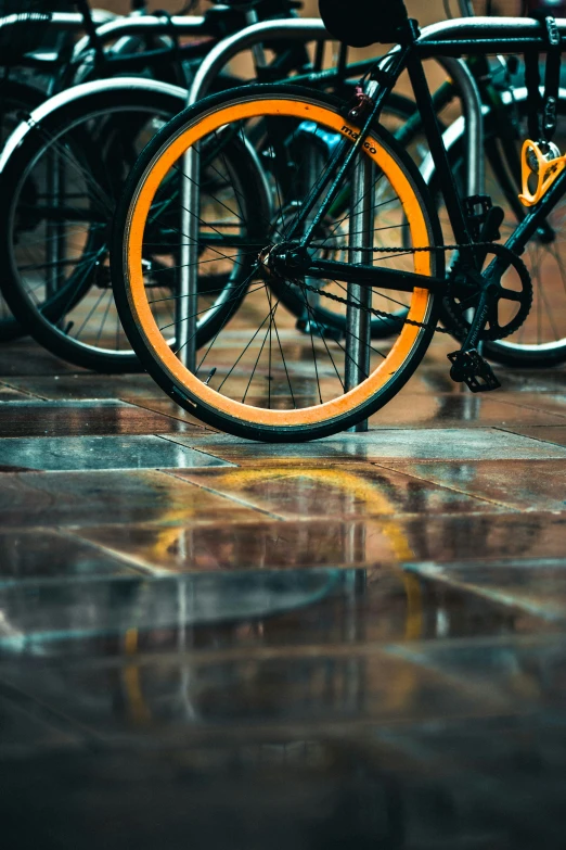 an orange bike parked by its rear tire