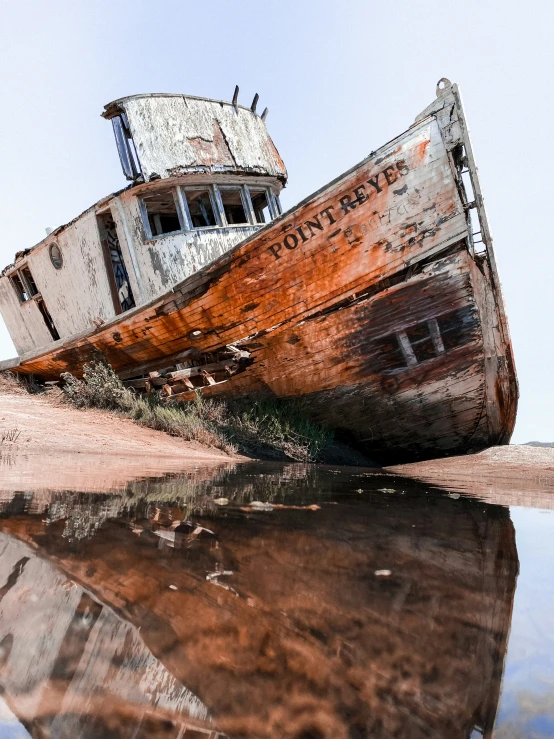 an old abandoned fishing boat sits in water