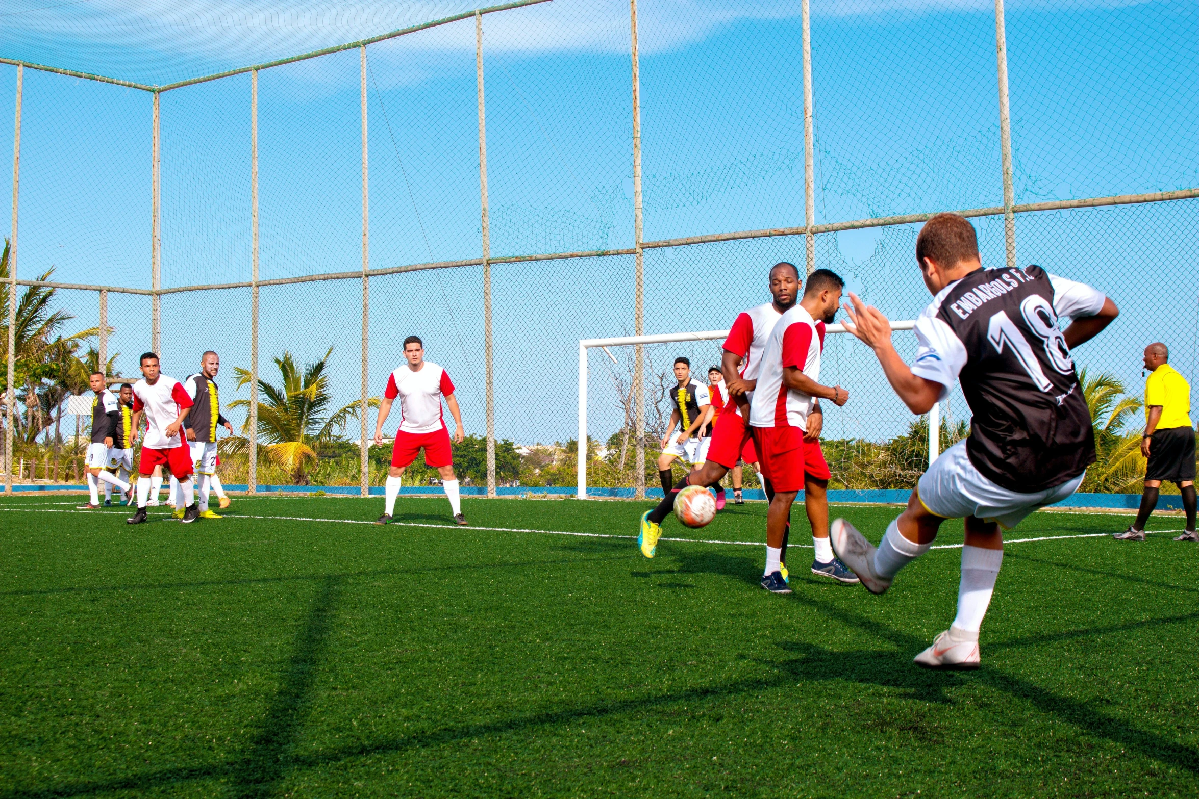 men are playing soccer on a grassy field