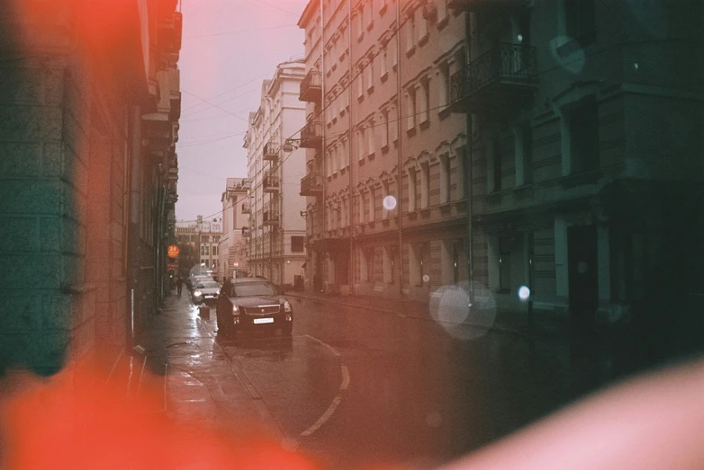 car traffic driving on a wet city street