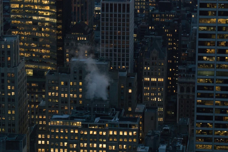 the skyscrs of an urban city at night with fog