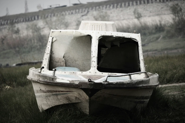 an old abandoned fishing boat in the grass
