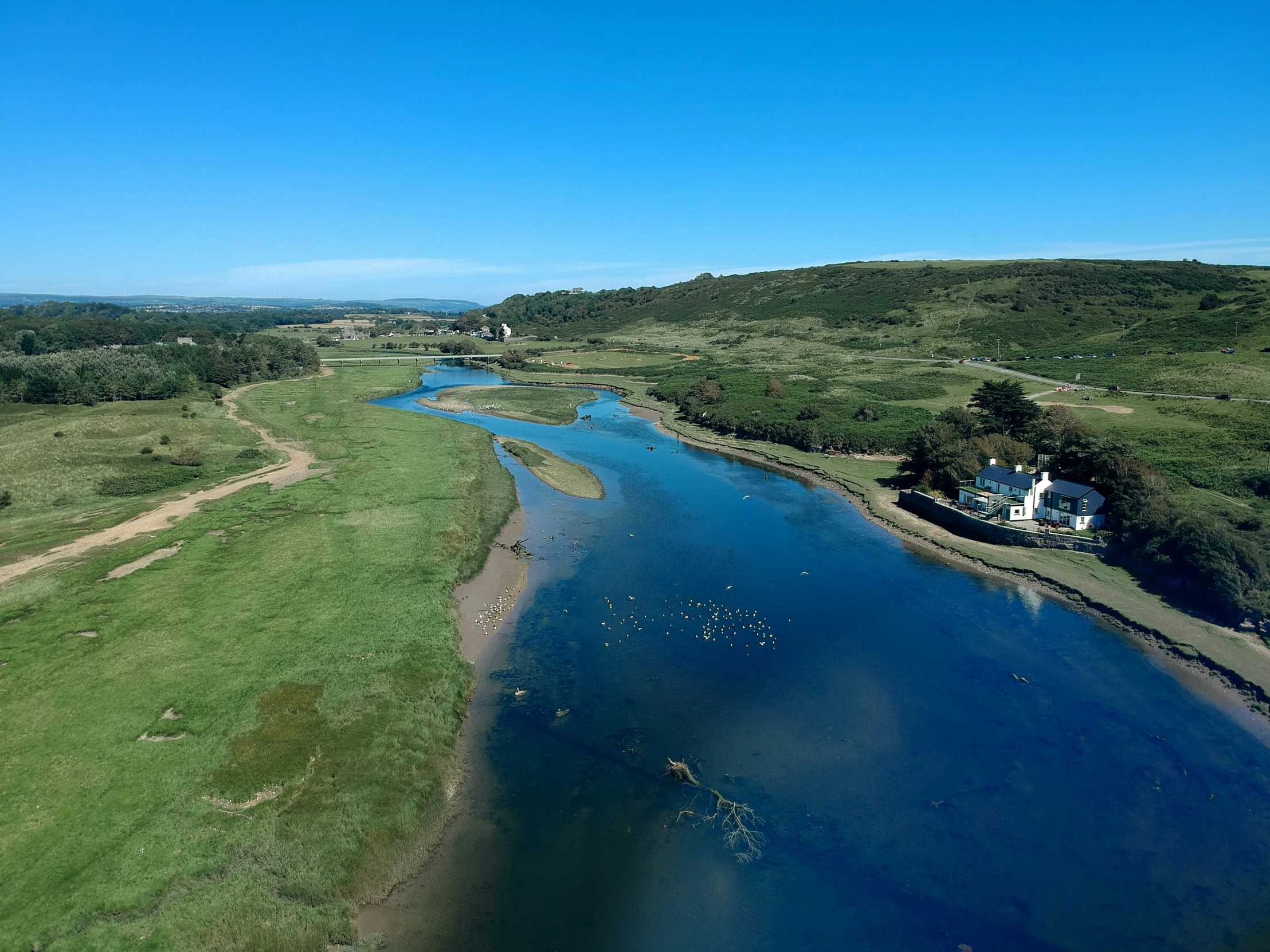 a lake surrounded by lots of green land