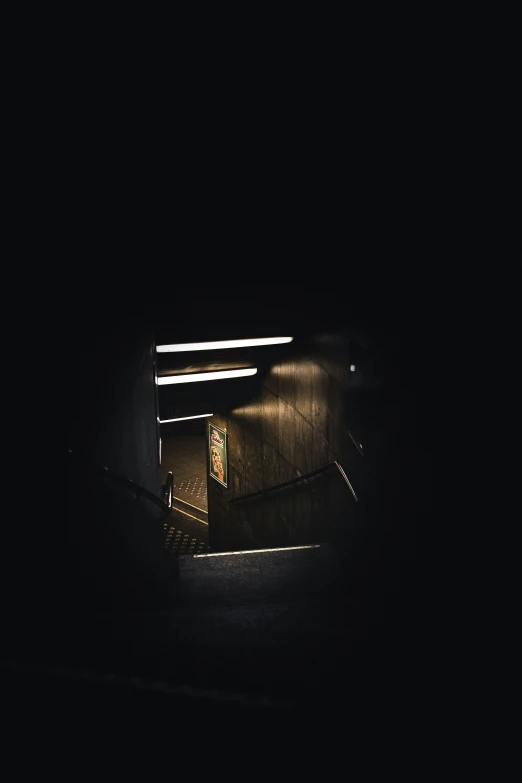 a person standing in the dark on top of stairs