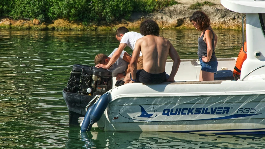 a group of people hanging out on the back of a boat