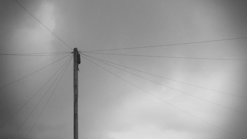 a dark gray sky has wires in it