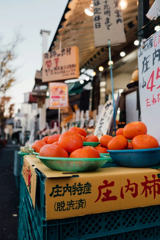 the fruit stand has lots of fruits in baskets