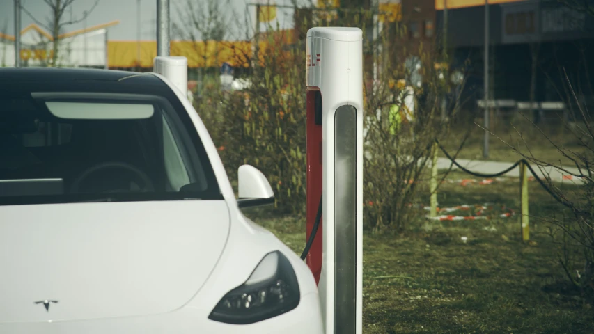 a car at a gas station that has a pole