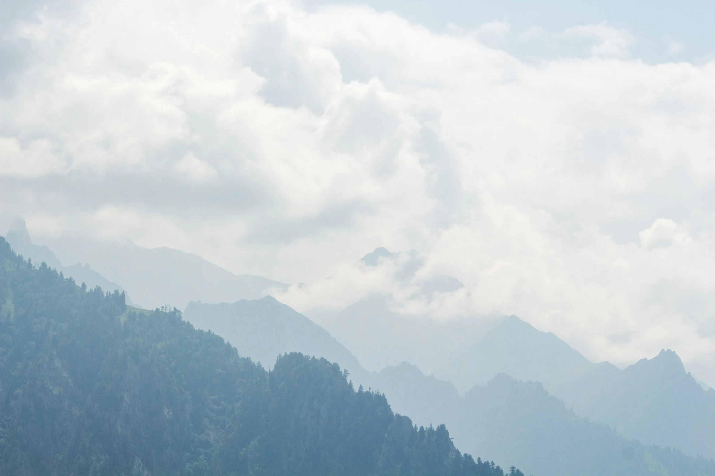 mountains with clouds and the sky in the background