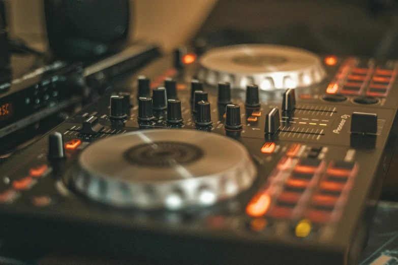 a dj mixes his track with his turntable and headphones