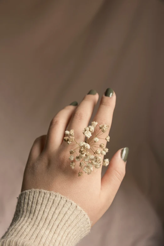 a woman's hand with many jewels in her finger