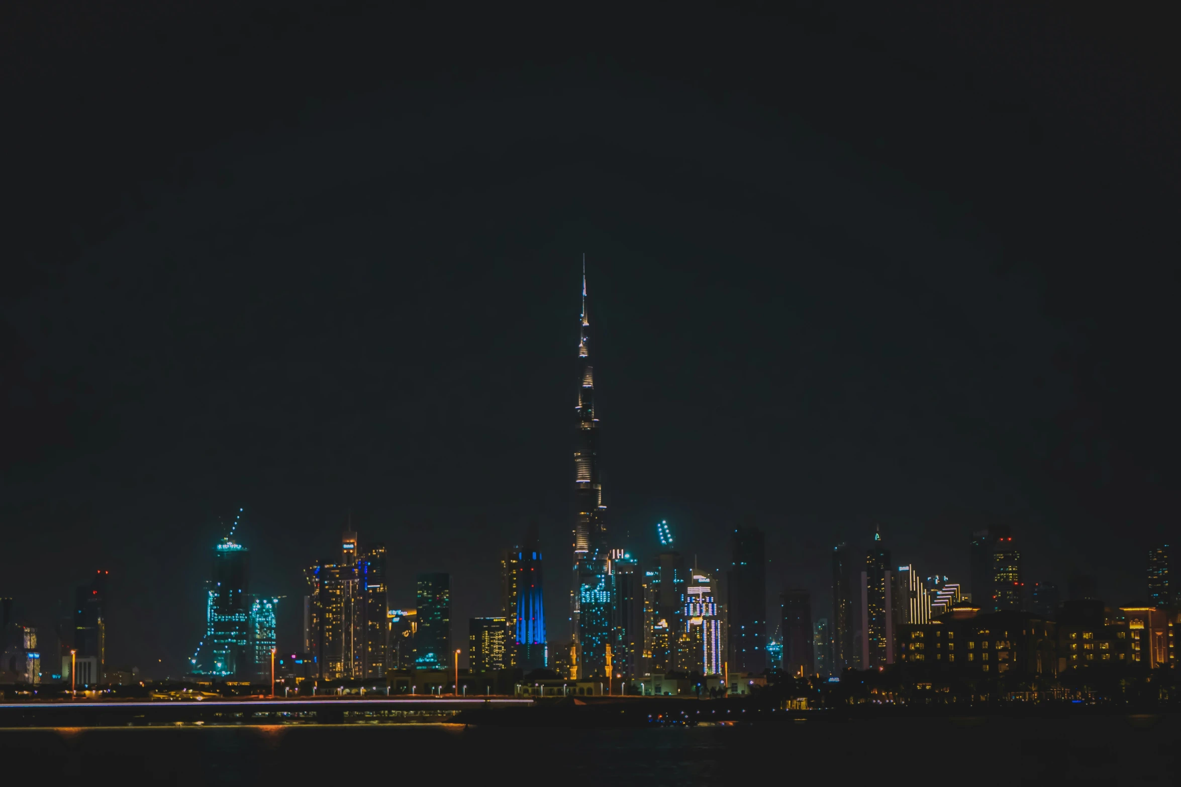 a city at night is shown lit up as well as it appears to be lit in green and blue