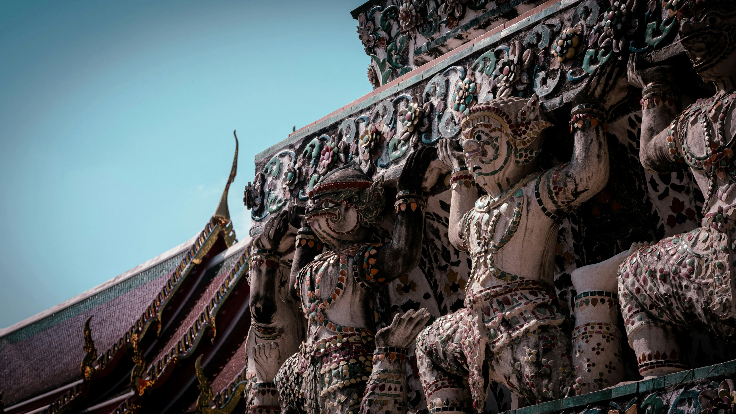 many statues of elephants are shown along a building