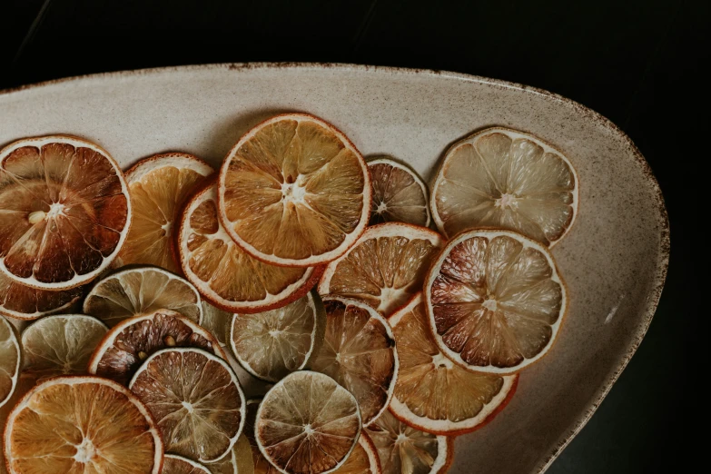 a white platter filled with sliced citrus fruits