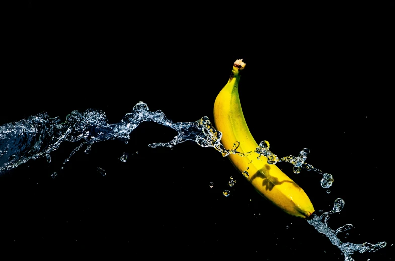 a yellow banana is in the water while it's raining