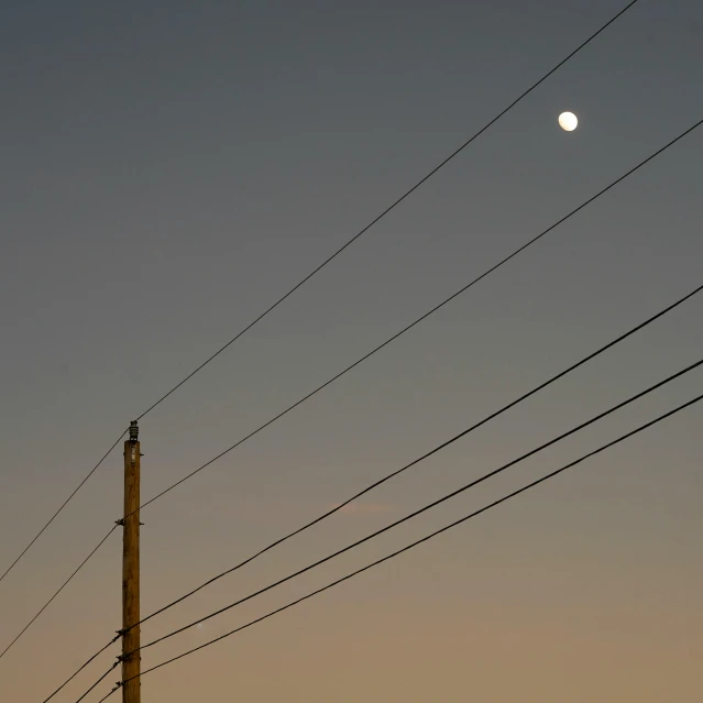 a street light that is sitting below power lines