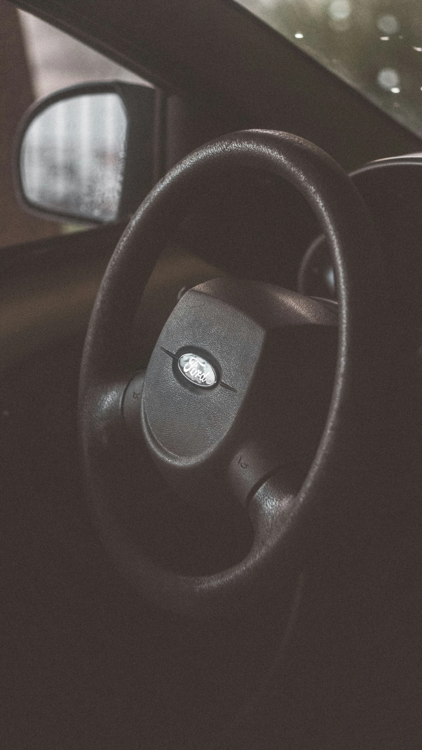 an interior of a modern vehicle with the dash board and hand controls