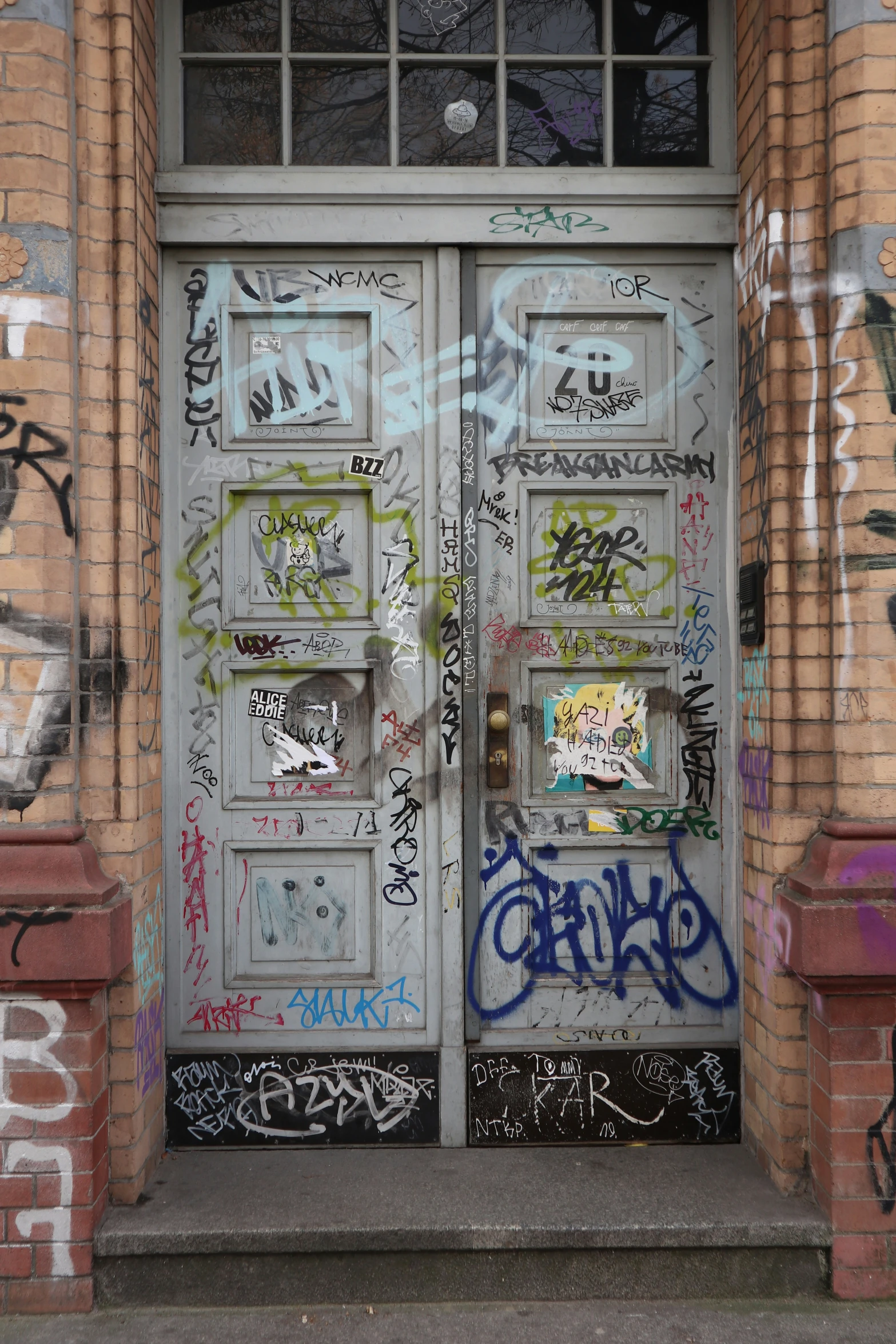the doors are covered with lots of graffiti