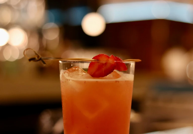 a glass with fruit garnish on a table