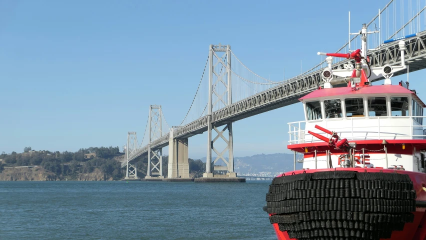 a boat in the water under a bridge