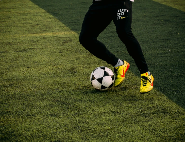 a man is running with a soccer ball