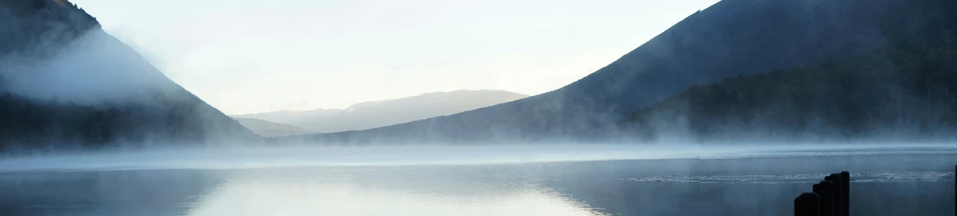 a lake surrounded by mountains is near by