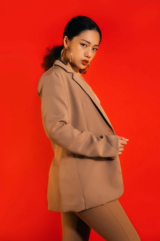 an african american woman in a camel colored coat